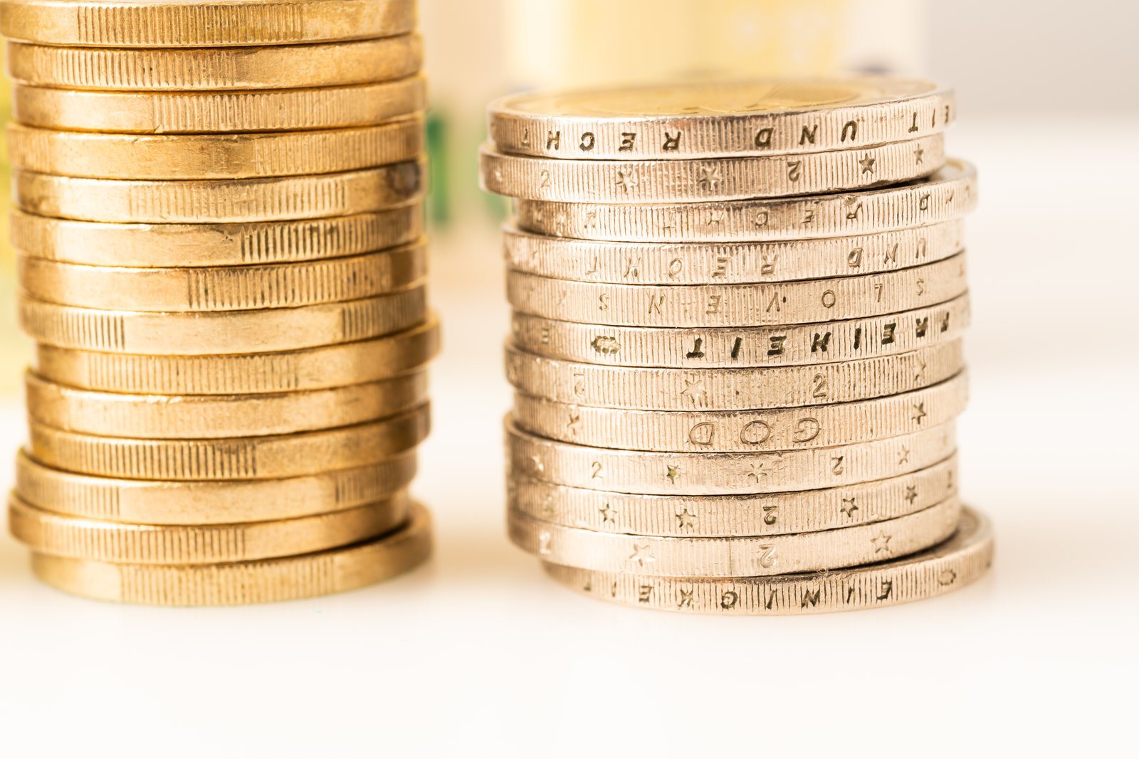 Two stacks of coins side by side on a white background
